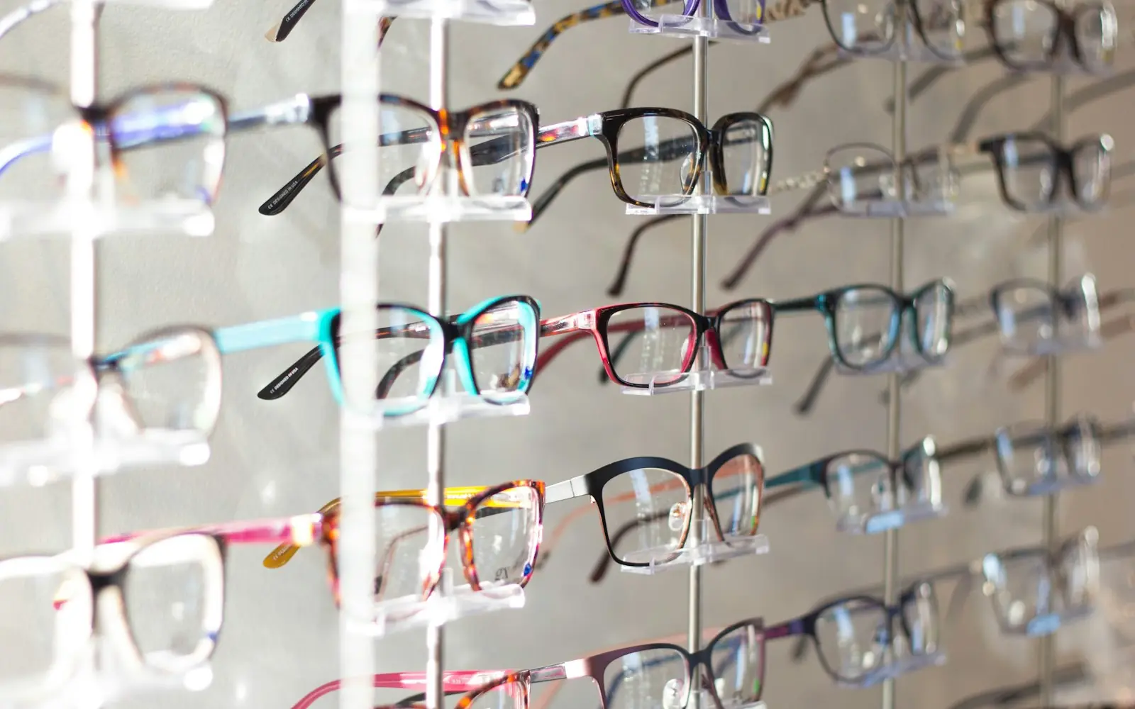 Eyeglass frames displayed on an optician's rack