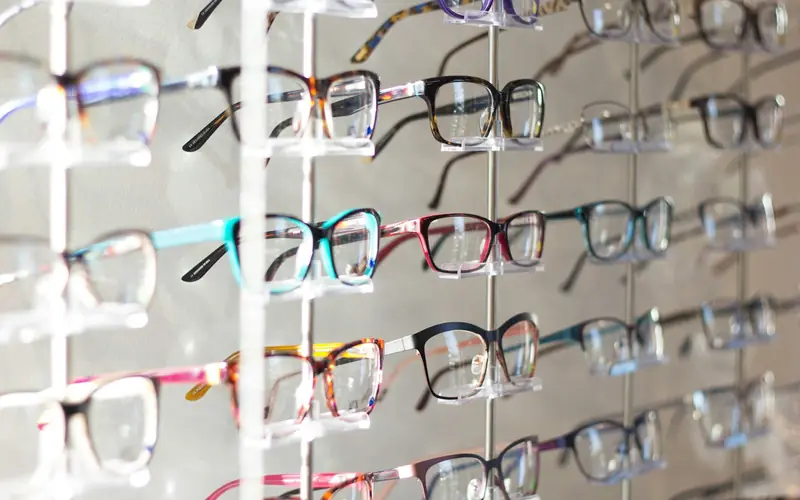 Eyeglass frames displayed on an optician's rack